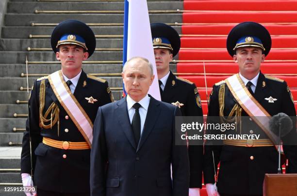 Russian President Vladimir Putin holds a minute of silence for pilots killed in clashes with the mutineers during a revolt by Wagner mercenaries as...