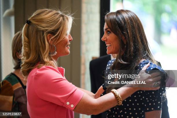Britain's Catherine, Princess of Wales reacts as she is welcomed by Edwina Grosvenor, founder of the charity One Small Thing, during a visit of "Hope...