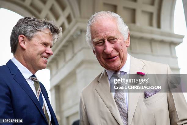 Britain's King Charles III listens to Architect and interior designer Ben Pentreath during a visit to Poundbury, south-west England on June 27, 2023.