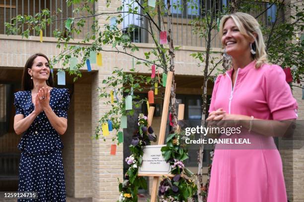 Britain's Catherine, Princess of Wales applauds Edwina Grosvenor, founder of the charity One Small Thing, at the end of her speech, during a visit of...