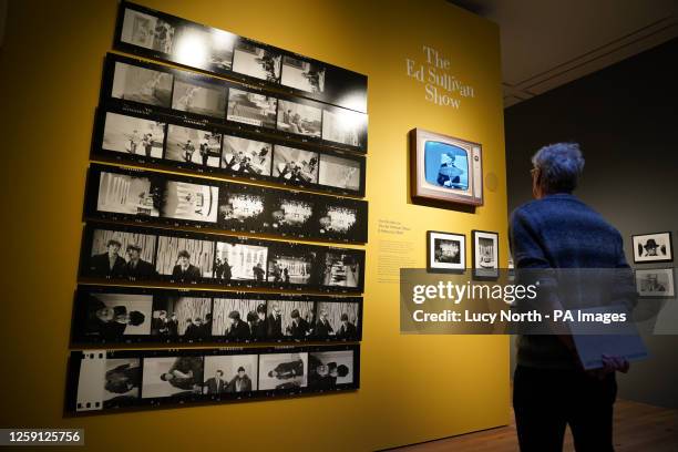 Person looking at photos during the press view of the new Sir Paul McCartney exhibition 'Photographs 1963-64: Eyes of the Storm', at the National...