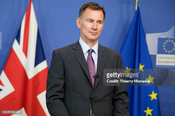 British Chancellor of the Exchequer Jeremy Hunt and the EU Commissioner for Financial services, financial stability and Capital Markets Union talk to...