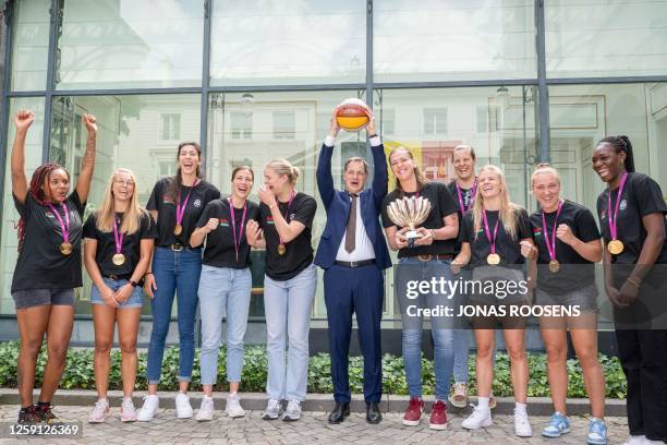 Belgian Prime Minister Alexander De Croo and Belgian Cats' players pose during a meeting at the Prime Minister's office, in Brussels, on June 27,...