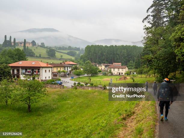 Group of pilgrims is seen arriving in a small town in the rural area of Asturias in Spain while walking the Camino Primitivo, on May 21st, 2023.