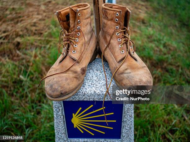 Couple of boots are seen placed on the top of a pylon that marks the Camino Primitivo in Galicia, Spain. On May 30th, 2023.