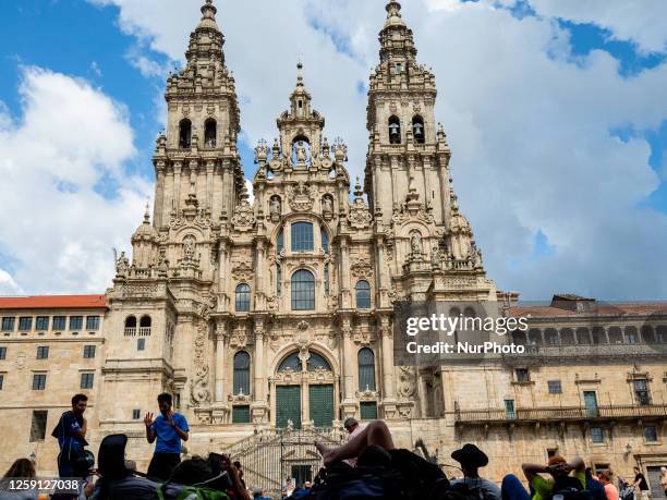 Pilgrims are seen resting in the famous Plaza del Obradoiro in the Santiago cathedral, after walking the Camino de Santiago. On June 2nd, 2023.