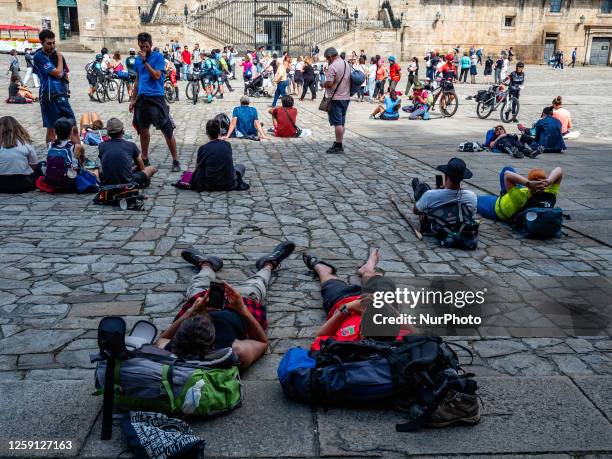 Pilgrims are seen resting in the famous Plaza del Obradoiro in the Santiago cathedral, after walking the Camino de Santiago. On June 2nd, 2023.