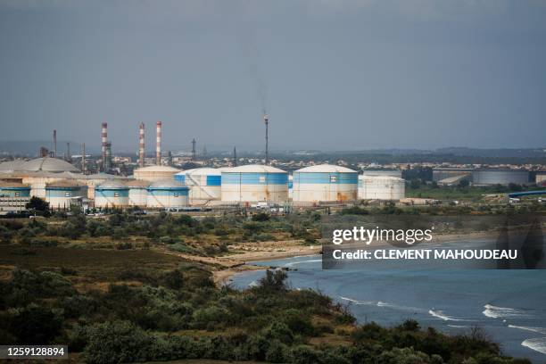 This photograph taken on June 22, 2023 shows the DPF "Depot Petrolier de France" petrol silos and its burning flare tower at the Marseille-Fos...