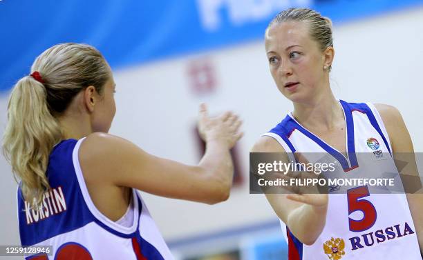 Russia's Oxana Rakhmatulina hi-fives with teamate Ilona Korstin after beating Belarus in their Group F qualifying round of the Women's European...