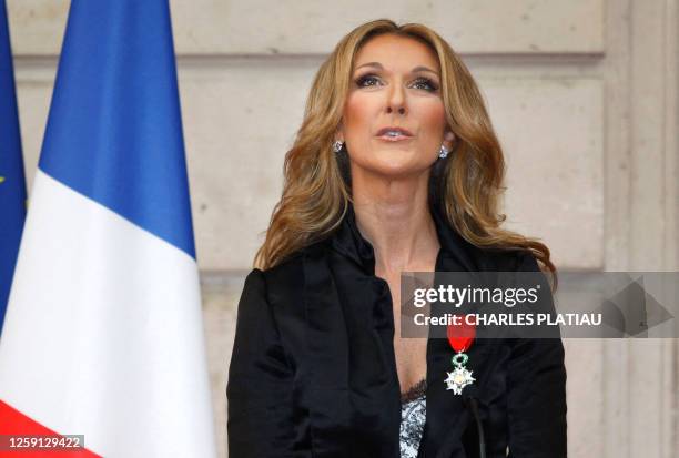 Canadian singer Celine Dion looks on after she was awarded with the France's Legion d'Honneur during a ceremony at the Elysee Palace in Paris on May...