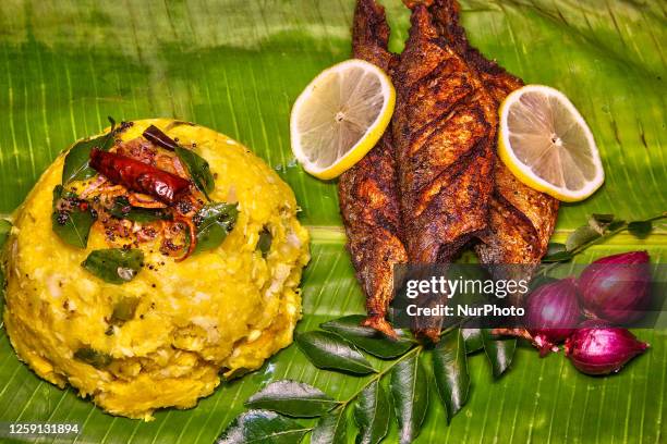 Kerala style fried fish with tapioca served on banana leaf in Toronto, Ontario, Canada, on July 26, 2023.
