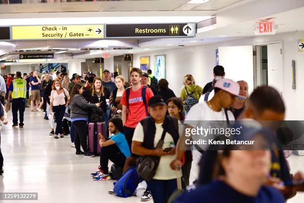 People wait for their flight reschedule inside of the Newark International Airport on June 27, 2023 in Newark, New Jersey. Newark Liberty...