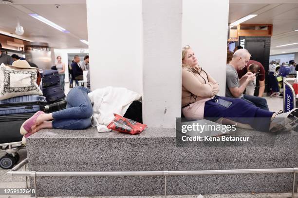 People rest waiting for their flight reschedule inside of the Newark International Airport on June 27, 2023 in Newark, New Jersey. Newark Liberty...