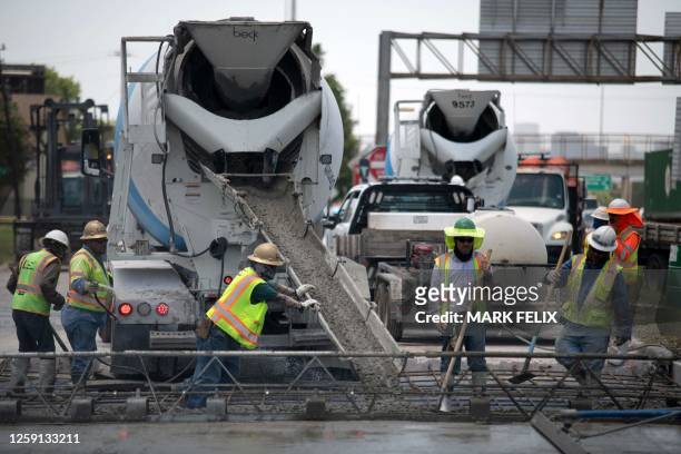 Construction crews work to repair a road that was damaged from the heat in Houston, Texas on June 27, 2023. A dangerous and prolonged heat wave...