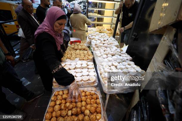 Palestinians do shopping at the market place ahead of the Eid al-Adha in Ramallah, West Bank on June 27, 2023.