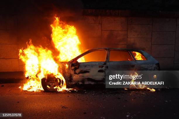 Photo shows a burning car on the sidelines of a demonstration in Nanterre, west of Paris, on June 27 after French police killed a teenager who...