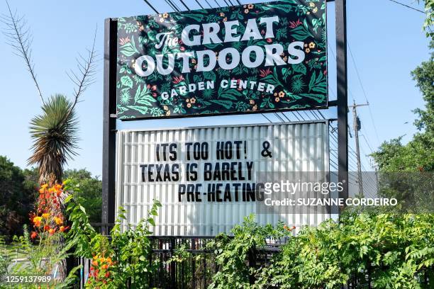 Garden center sign reading "Its too hot" on Congress Avenue on June 27, 2023 in Austin, Texas. A dangerous and prolonged heat wave blanketed large...