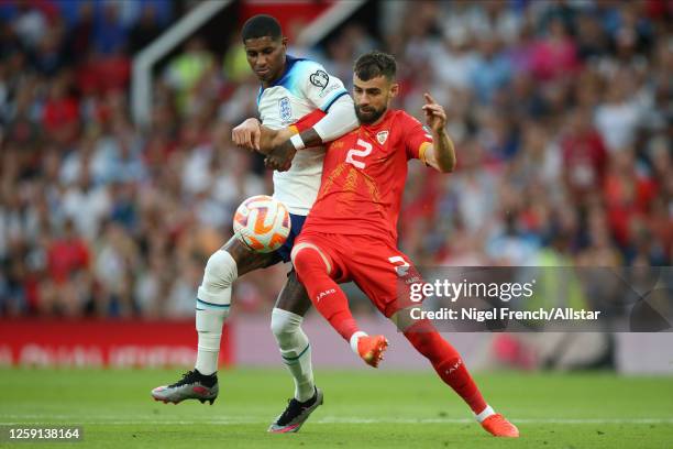 Marcus Rashford of England and Egzon Bejtulai of North Macedonia challenge during the UEFA EURO 2024 Qualifying Round Group C match between England...