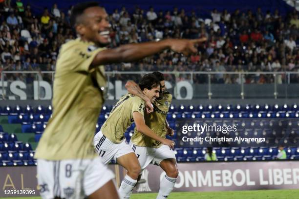 Igor Silvera of Atletico Mineiro celebrates with teammate Hulk after scoring the team's first goal during a group G match between Libertad and...