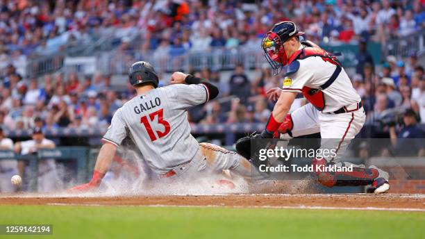 Joey Gallo of the Minnesota Twins scores off an Edouard Julien sacrifice as Sean Murphy of the Atlanta Braves defends the plate during the fourth...