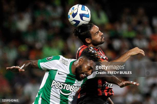 Atletico Nacional's defender Cristian Devenish and Patronato's forward Enzo Diaz fight for the ball during the Copa Libertadores group stage second...