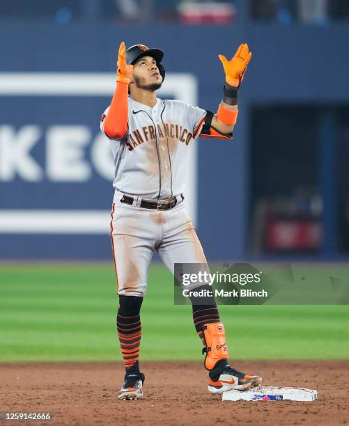 Thairo Estrada of the San Francisco Giants celebrates his two-RBI double during the ninth inning against the Toronto Blue Jays at Rogers Centre on...