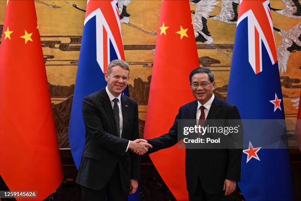 New Zealand Prime Minister Chris Hipkins shakes hands with Chinese Premier Li Qiang during a signing ceremony at The Great Hall Of The People on June...