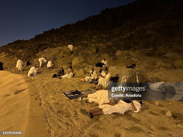Muslim prospective pilgrims collect stones for the ritual casting of stones at the devil at Muzdalifah after they performed Waqfa prayer in Mecca,...