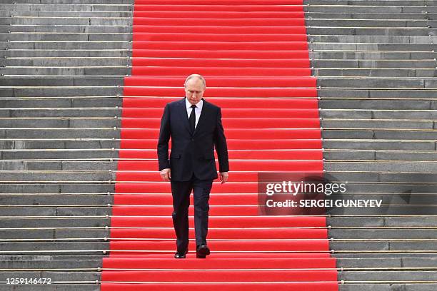 Russian President Vladimir Putin walks down the steps to address troops from the defence ministry, National Guard, FSB security service and interior...