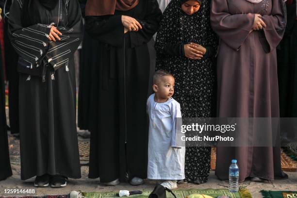 Palestinian Muslims attend the Eid al-Adha morning prayer in Gaza City on June 28 as Muslims across the world celebrated the first day of the Feast...