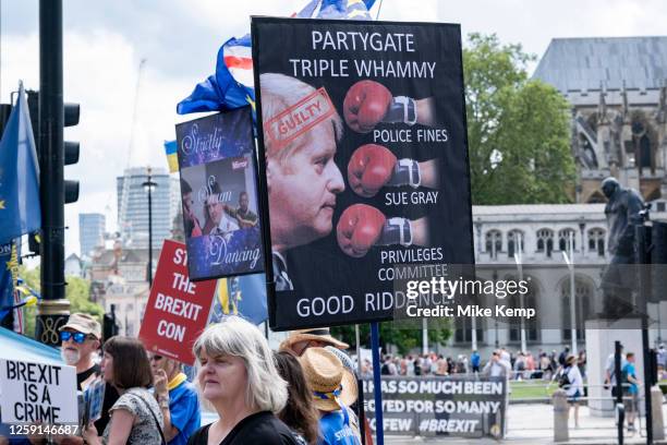 Anti-Brexit protesters continue their campaign against Brexit and the Conservative government in Westminster with a placard featuring Boris Johnson...