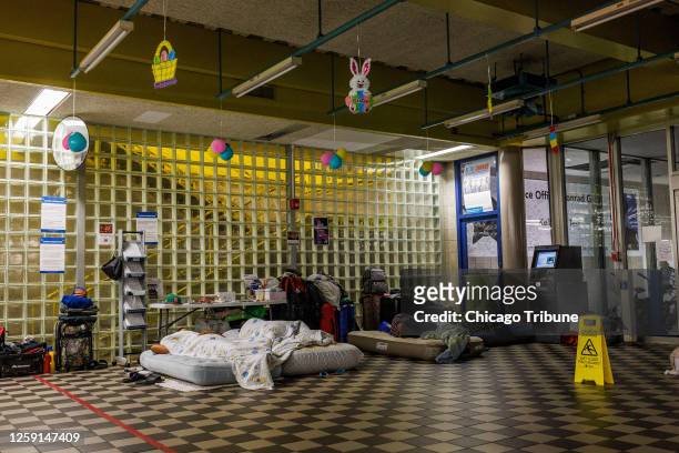 Asylum-seekers sleep in the lobby of the District 5 police station on June 22, 2023.