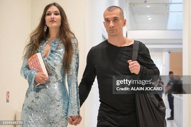 Russian artist Piotr Pavlenski and his companion Alexandra de Taddeo , holding her book "L'Amour L'Amour", arrive for their trial after the couple...