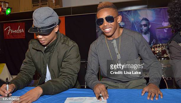 Recording artist Roc Royal and Prodigy sign autographs for fans at the celebration for Mindless Behavior's Girl album release with an in-store...