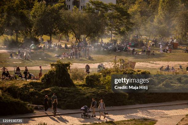 Visitors enjoy warm weather in Mauerpark in Berlin on July 25, 2020 in Berlin, Germany. For the German capital, the COVID-19 pandemic has been...