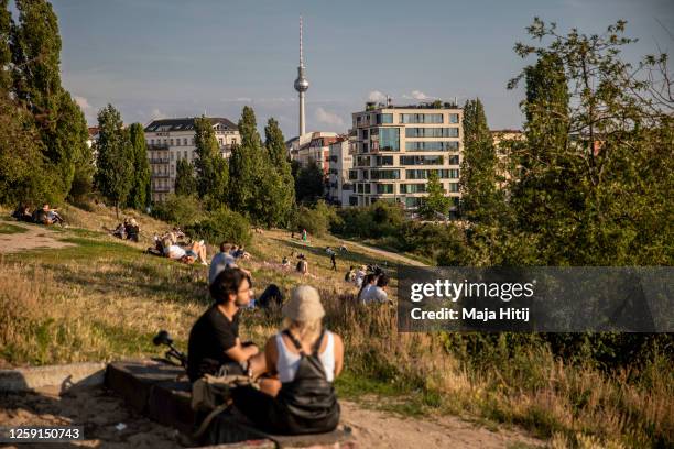 Visitors enjoy warm weather in Mauerpark in Berlin on July 25, 2020 in Berlin, Germany. For the German capital, the COVID-19 pandemic has been...