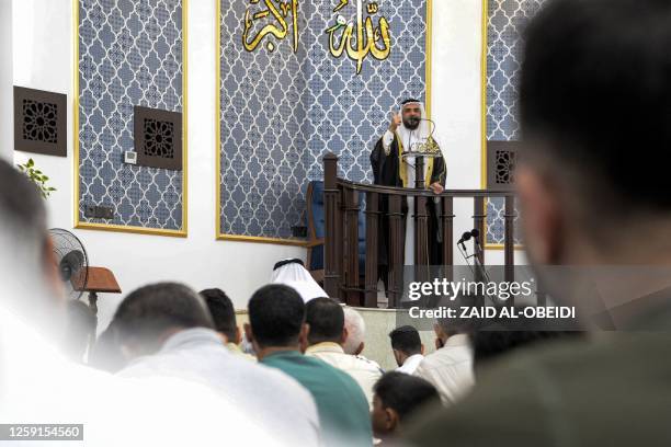 An imam gives a sermon before Sunni Muslim worshippers during the morning prayers for Eid al-Adha at the Mohamed al-Amin mosque on the eastern side...