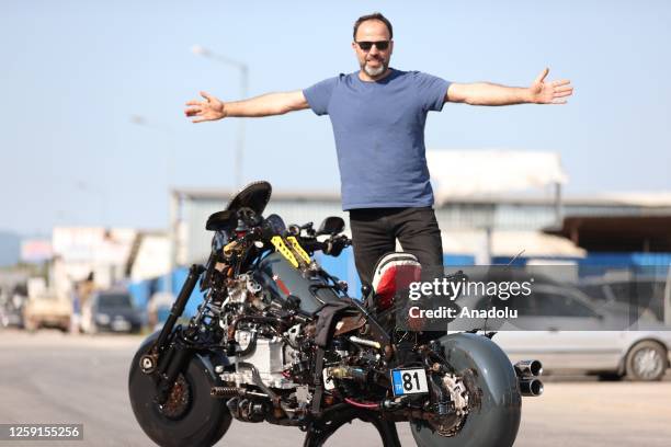 Murat Cetin, a mechanic from Turkiye's Duzce, poses with the motorcycle he made by using 1453 waste parts from vehicles in Duzce, Turkiye on June 25,...