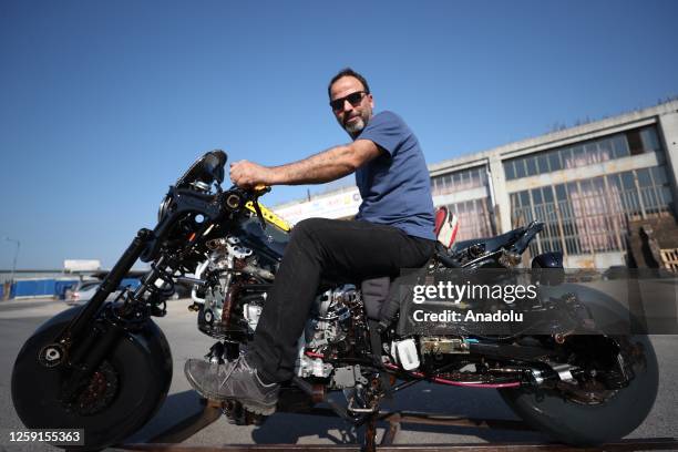 Murat Cetin, a mechanic from Turkiye's Duzce, poses with the motorcycle he made by using 1453 waste parts from vehicles in Duzce, Turkiye on June 25,...