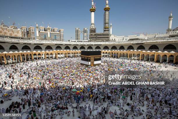 Muslim pilgrims gather around the Kaaba, Islam's holiest shrine, at the Grand Mosque in the holy city of Mecca early on June 28 as they perform the...