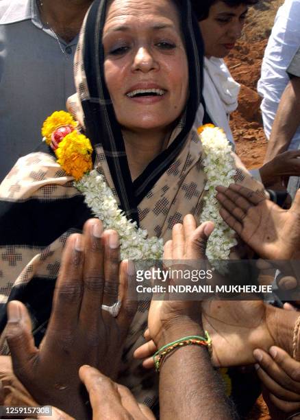 Indian opposition leader and Congress party president Sonia Gandhi greets supporters during a rally at Vadiampet village in Anantpur district in the...