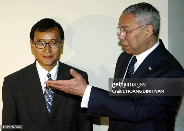Visiting US State Secretary Colin Powell shows the way to Cambodian opposition leader Sam Rainsy as they meet 19 June 2003 in Phnom Penh. Powell, who...