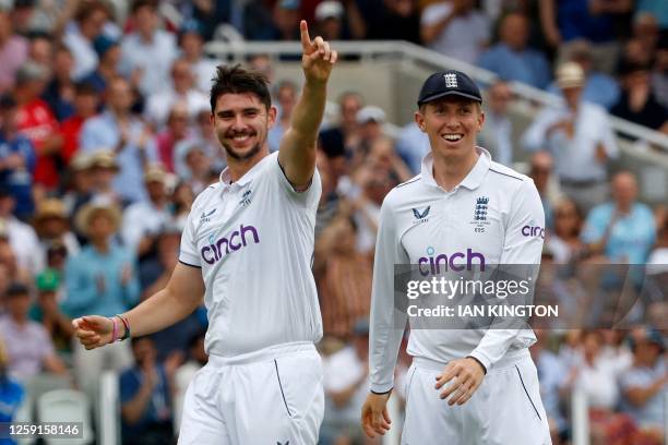 England's Josh Tongue celebrates taking the wicket of Australia's Usman Khawaja for 17 runs on day one of the second Ashes cricket Test match between...