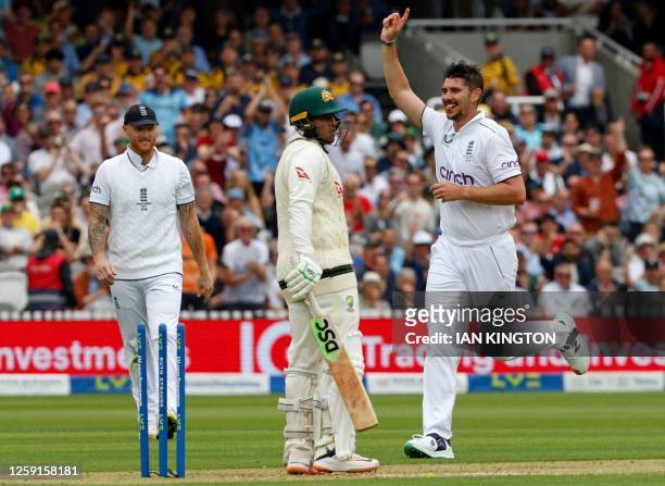 England's Josh Tongue celebrates taking the wicket of Australia's Usman Khawaja for 17 runs on day one of the second Ashes cricket Test match between...