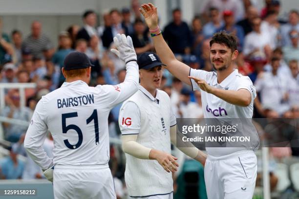 England's Josh Tongue celebrates taking the wicket of Australia's Usman Khawaja for 17 runs on day one of the second Ashes cricket Test match between...