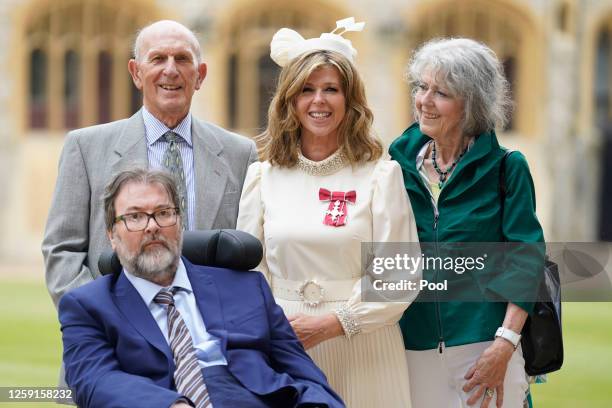 Kate Garraway, with her husband Derek Draper and her parents Gordon and Marilyn Garraway, after being made a Member of the Order of the British...