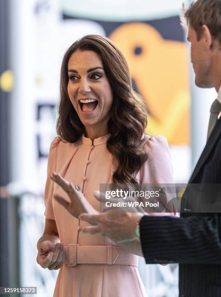 Catherine, Princess of Wales, Patron of the V&A, waves at children next to Tristram Hunt, Director of Victoria and Albert Museum, as she officially...