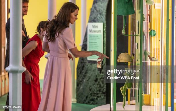 Catherine, Princess of Wales, Patron of the V&A, spots a Kermit the frog toy in a display case as she officially opens The Young V&A, with children...