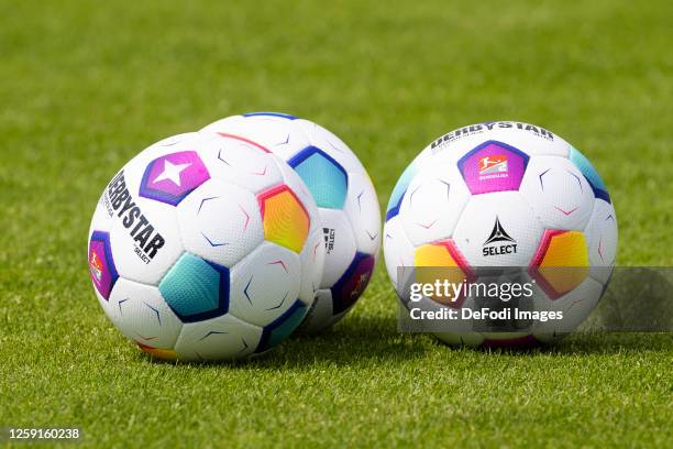 Three Derbystar soccer balls lie on the grass during a training session at Parkstadion on June 26, 2023 in Gelsenkirchen, Germany. FC Schalke 04...