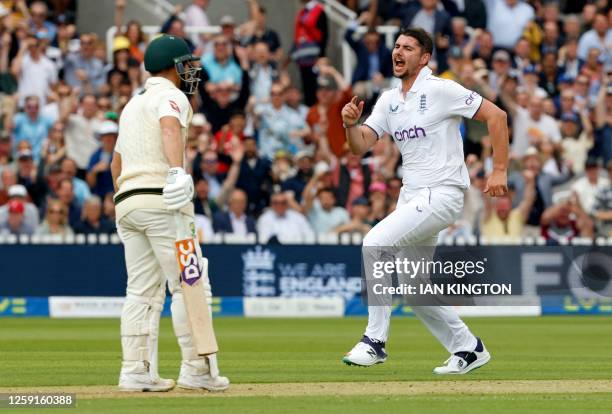 England's Josh Tongue celebrates taking the wicket of Australia's David Warner for 66 runs on day one of the second Ashes cricket Test match between...